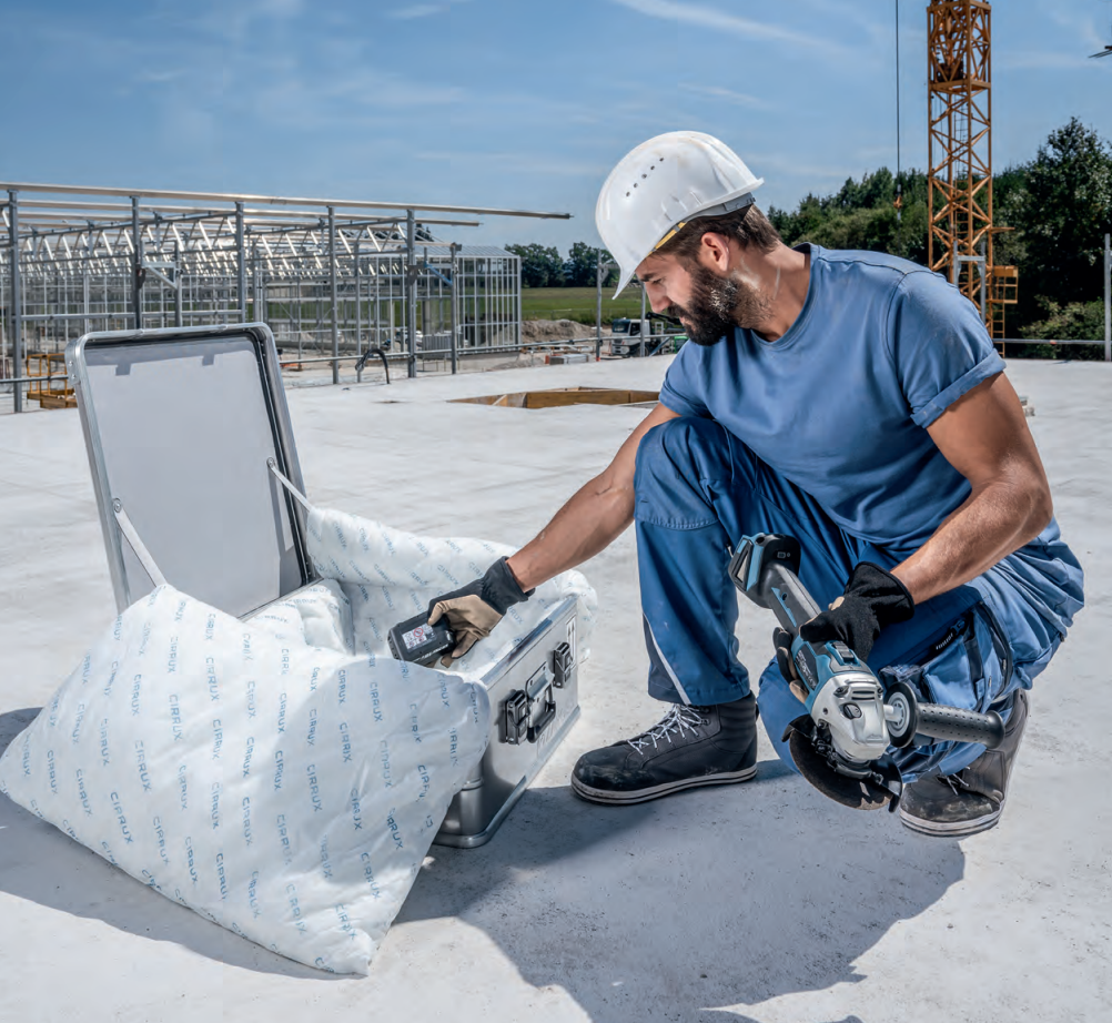Man placing a battery into a battery box.